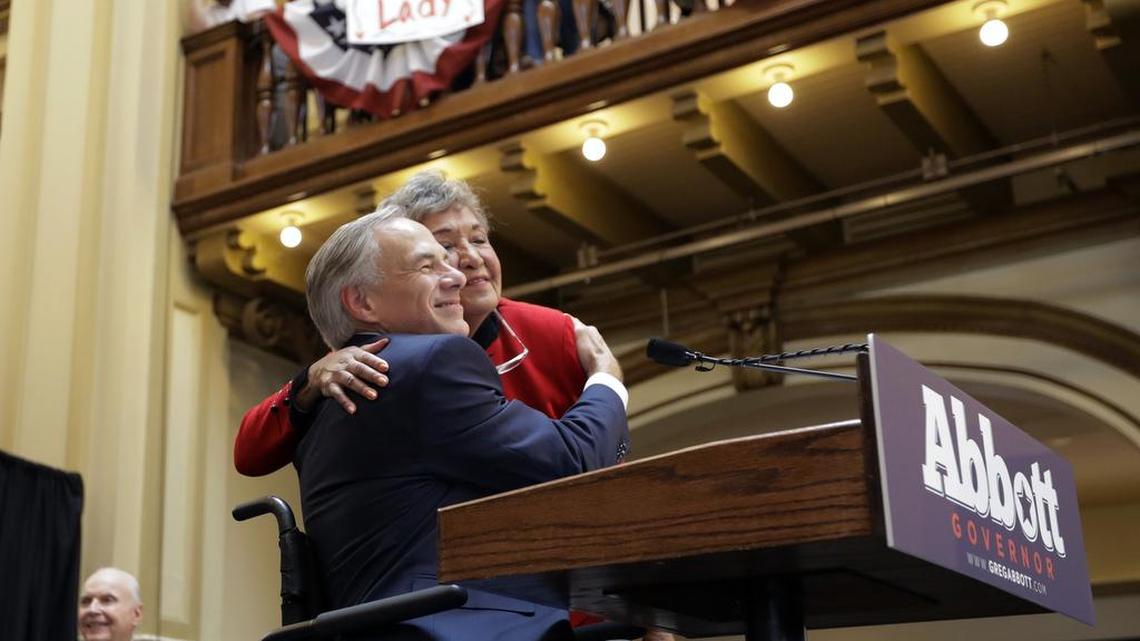 Texas Gov. Greg Abbott is hugged by his mother-in-law, Maria de la luz Segura Phalen, right, during a rally where he announced his bid for re-election Friday in San Antonio.