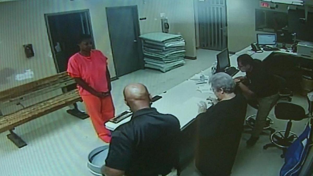 Sandra Bland stands in front of a desk at the Waller County Jail in Hempstead after her arrest.