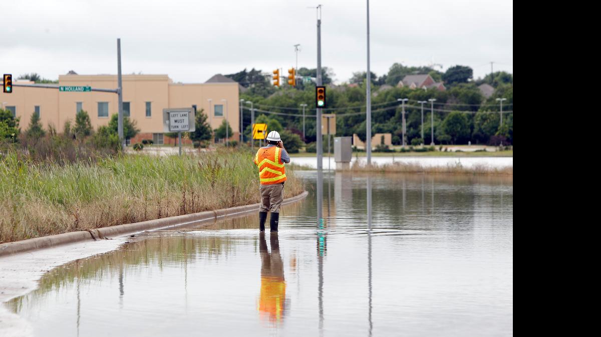 
A TxDOT employee photographs a flooded southbound Texas 360 at Holland Road in Mansfield in this archive photo from May 29, 2015. 
