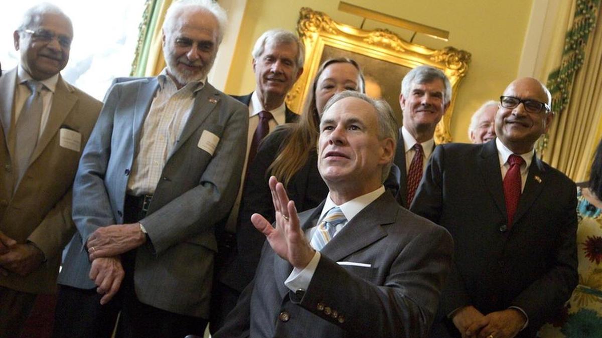 Gov. Greg Abbott discusses the Governor's University Research Initiative grant program at the Governor's Mansion during a reception on March 6. Renowned electrical engineering professor Tom Overbye (third from the right), who recently joined Texas A&M University, is shown standing behind Abbott