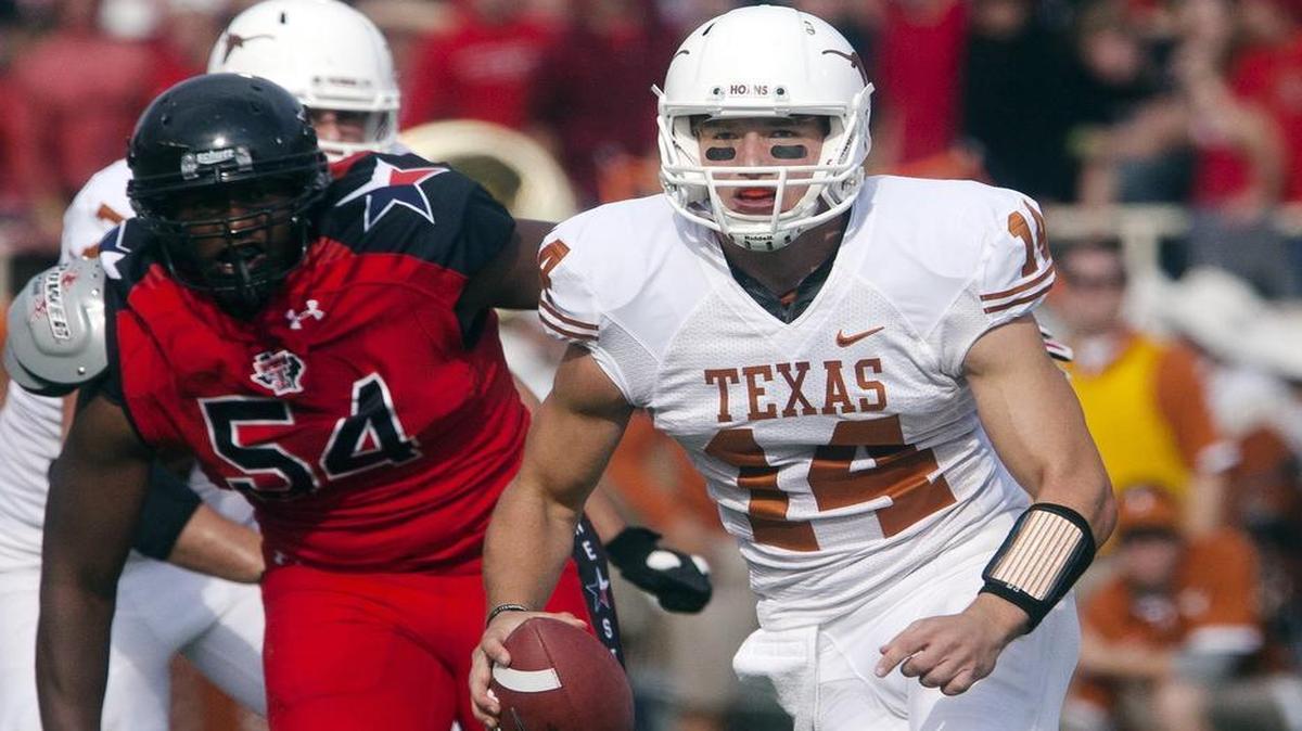 Texas quarterback David Ash scrambles away from Texas Tech's defensive end Dartwan Bush during a game in 2012, his most successful season at UT. That season he completed 214 of 318 passes for 19 touchdowns and led the Longhorns to a 9-4 record.