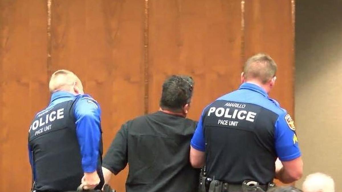Kip Billups is escorted out of an Amarillo City Council meeting after refusing to follow Mayor Ginger Nelson’s order for the audience not to clap during public comment.