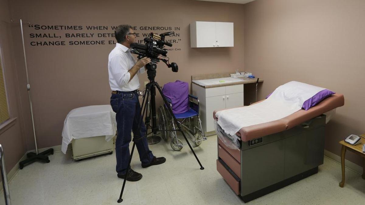 A member of the media works in a room formally used as an examination room for abortions in Austin. Texas health officials in July proposed new rules to prohibit abortion providers from disposing of fetal remains in sanitary landfills.