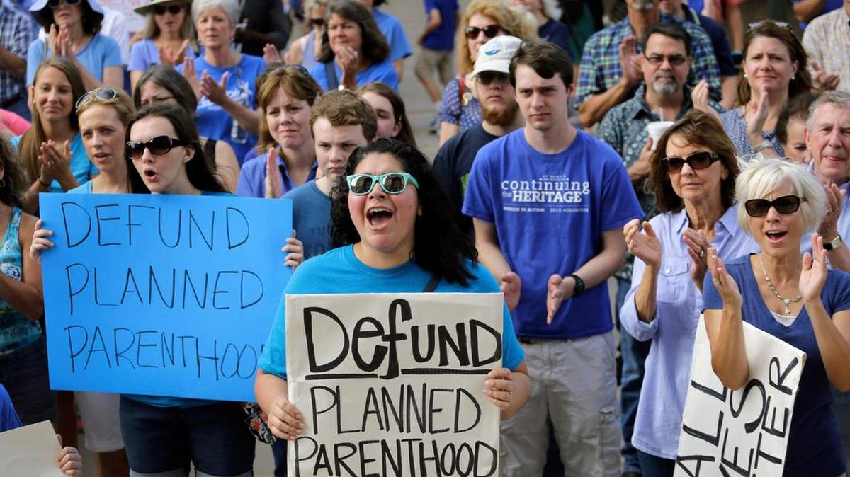 
FILE: In this July 28, 2015, file photo, Erica Canaut, center, cheers as she and other anti-abortion activists rally on the steps of the Texas Capitol in Austin, Texas, to condemn the use in medical research of tissue samples obtained from aborted fetuses. Texas announced Monday, Oct. 19, 2015, that it was cutting off Medicaid funding to Planned Parenthood clinics following undercover videos of officials discussing fetal tissue, potentially triggering a legal fight like the one unfolding in neighboring Louisiana. (AP Photo/Eric Gay, File)
