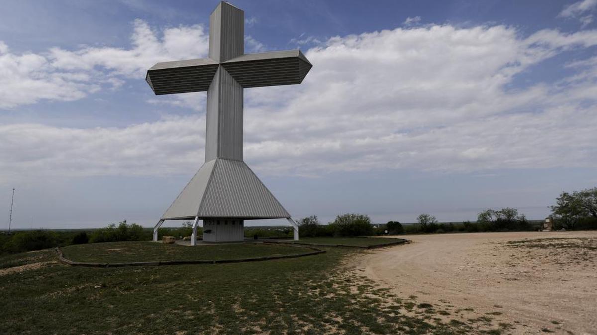 Clouds pass over the 99-foot steel cross overlooking Ballinger. Businessman Jim Studer commissioned the cross in the early 1990s.