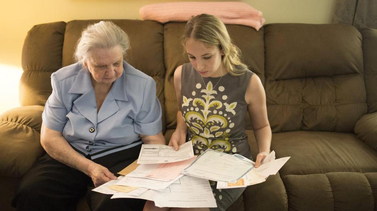 Myrtle Delahuerta, 85, goes over documents at her home with attorney Abbie Kamin in Houston last month. Delahuerta has tried unsuccessfully for two years to obtain a voter ID.
