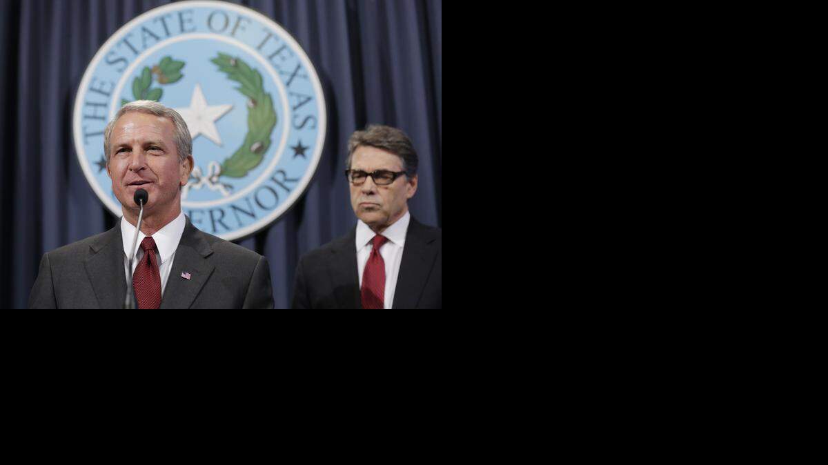 
Dr. Kyle Janek, Texas health and human services executive commissioner, speaks in October about Ebola prevention efforts in Austin. Gov. Rick Perry is at right.
