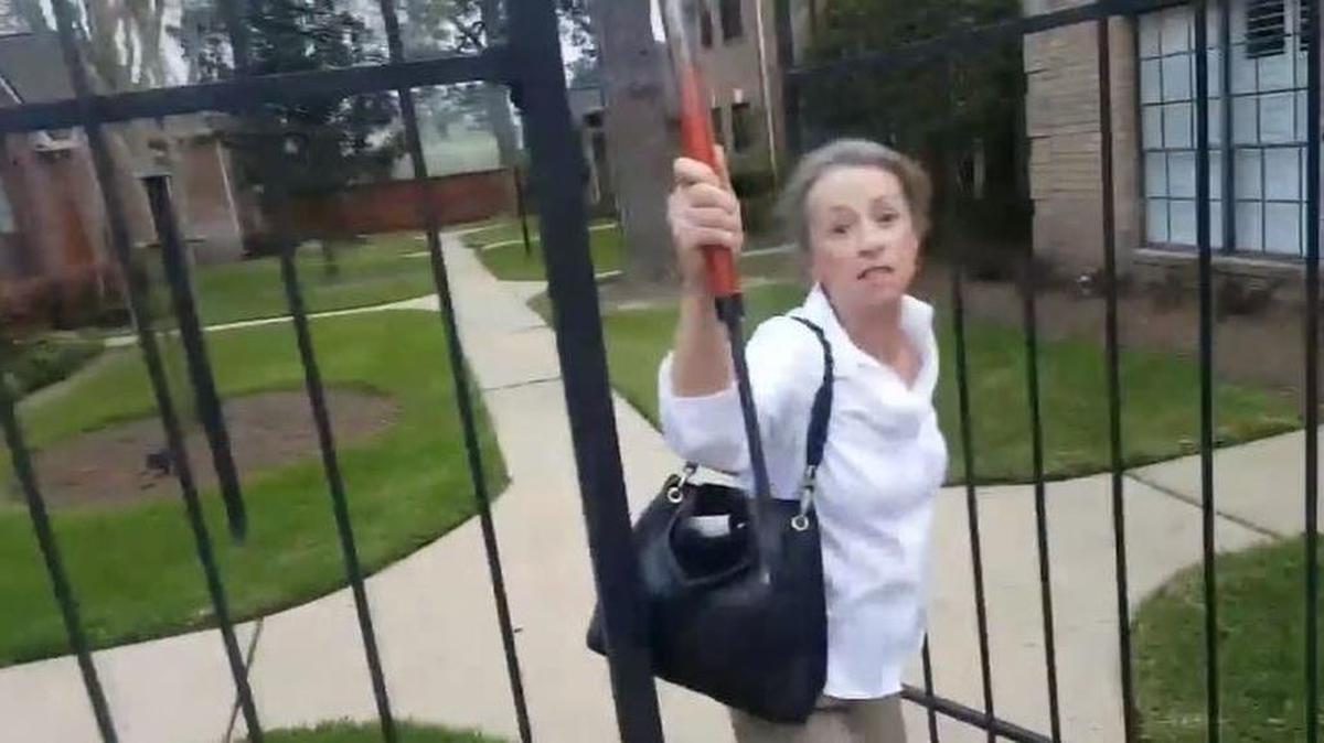 Dallas Rose Lott allegedly approached neighbor Rodrigo Camus with a club raised.