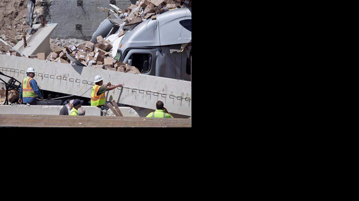 
Workers are at the scene after a tractor-trailer slammed into construction beams being used to build a bridge across Interstate 35 in Salado, Texas.
