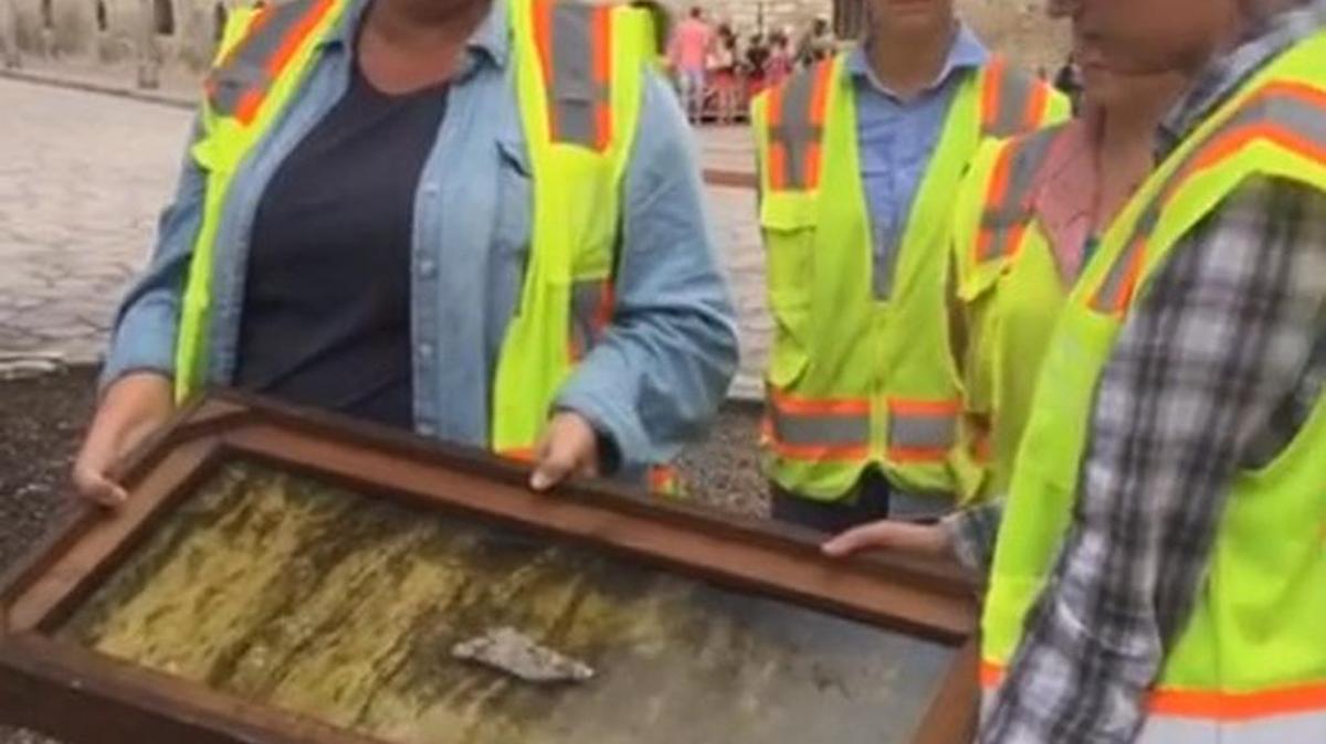 The archaeological team shows the tip of a Mexican sword recovered last week in an excavation at the southern wall of the Alamo.