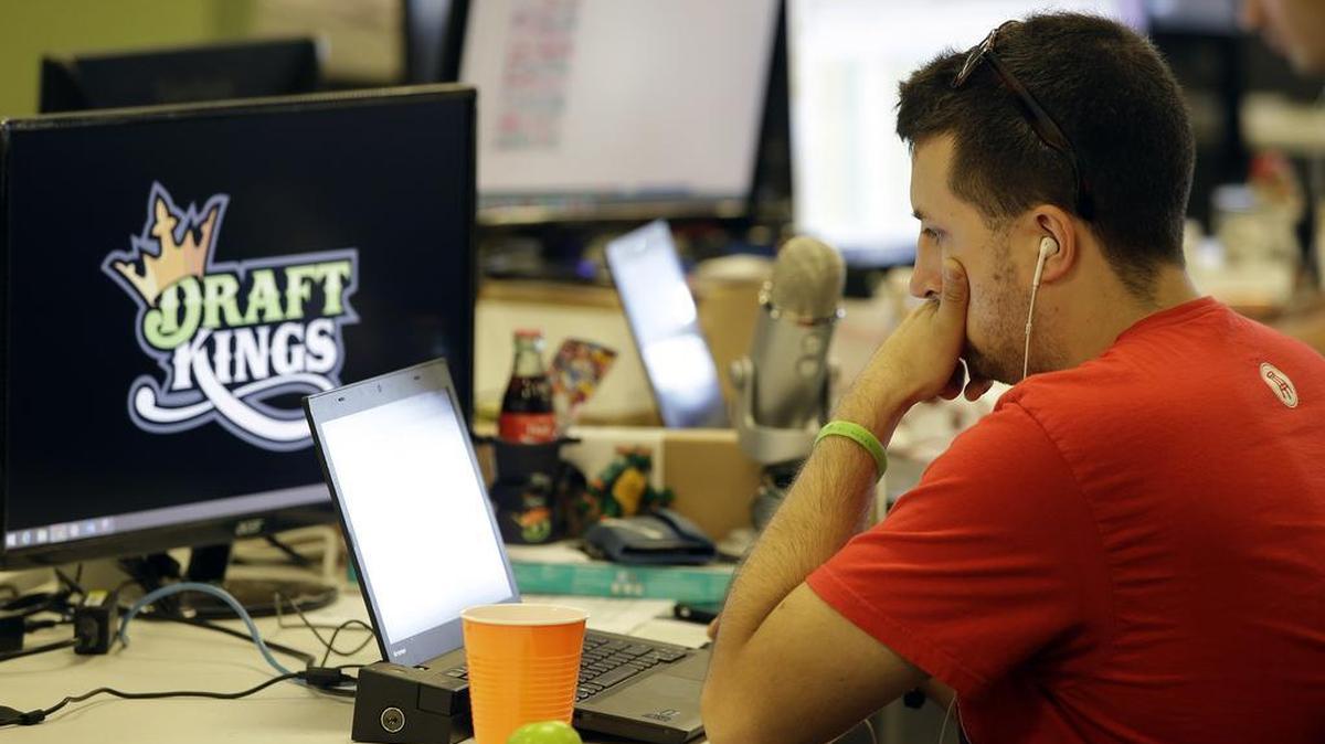 Devlin D'Zmura, a tending news manager at DraftKings, a daily fantasy sports company, works on his laptop at the company's offices in Boston.
