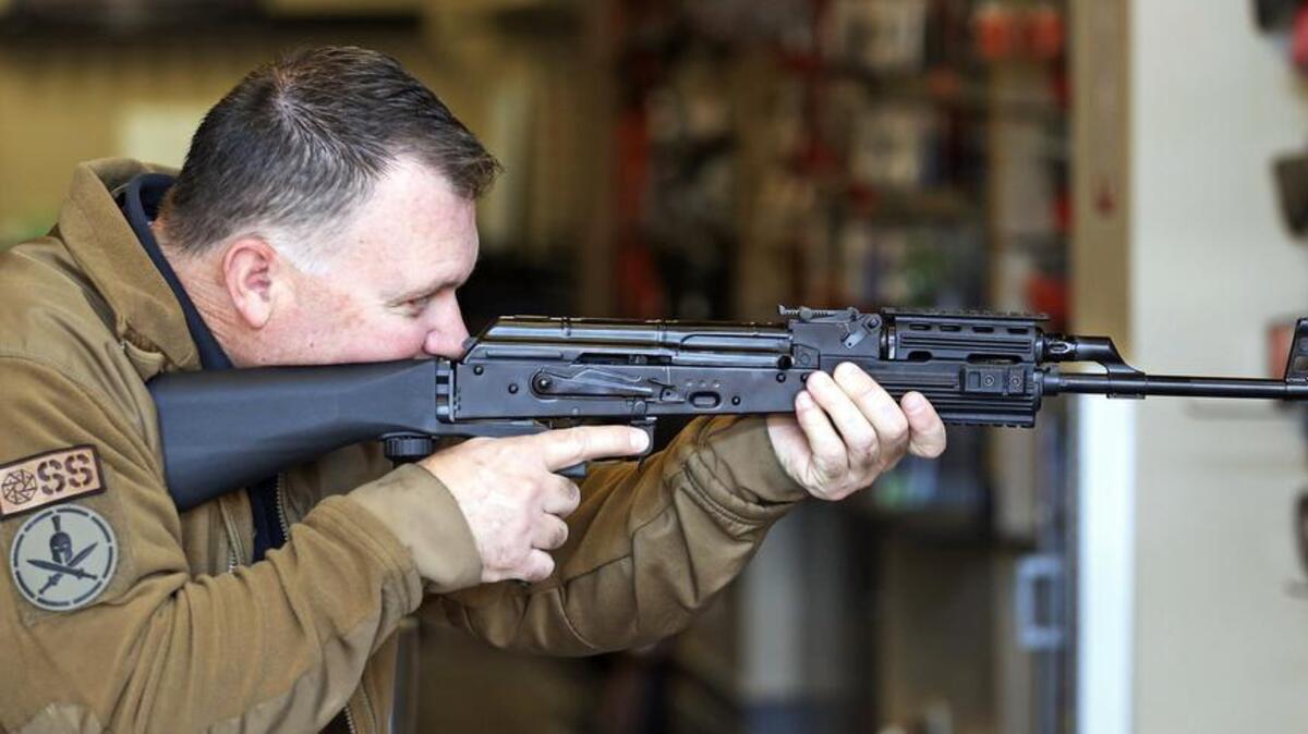 Clark Aposhian, chairman of the Utah Shooting Sports Council, demonstrates how a a “bump stock” works when attached to a semi-automatic rifle at a shooting range in South Jordan, Utah.