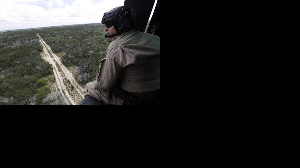 
A U.S. Customs and Border Protection Air and Marine agent pears out of the open door of a helicopter during a patrol flight near the Texas-Mexico border near McAllen, Texas. The U.S. Border Patrol would have greater freedom to patrol federally protected lands if U.S. Rep. Michael McCaul, R-Austin, has better luck on immigration legislation with a new Congress.
