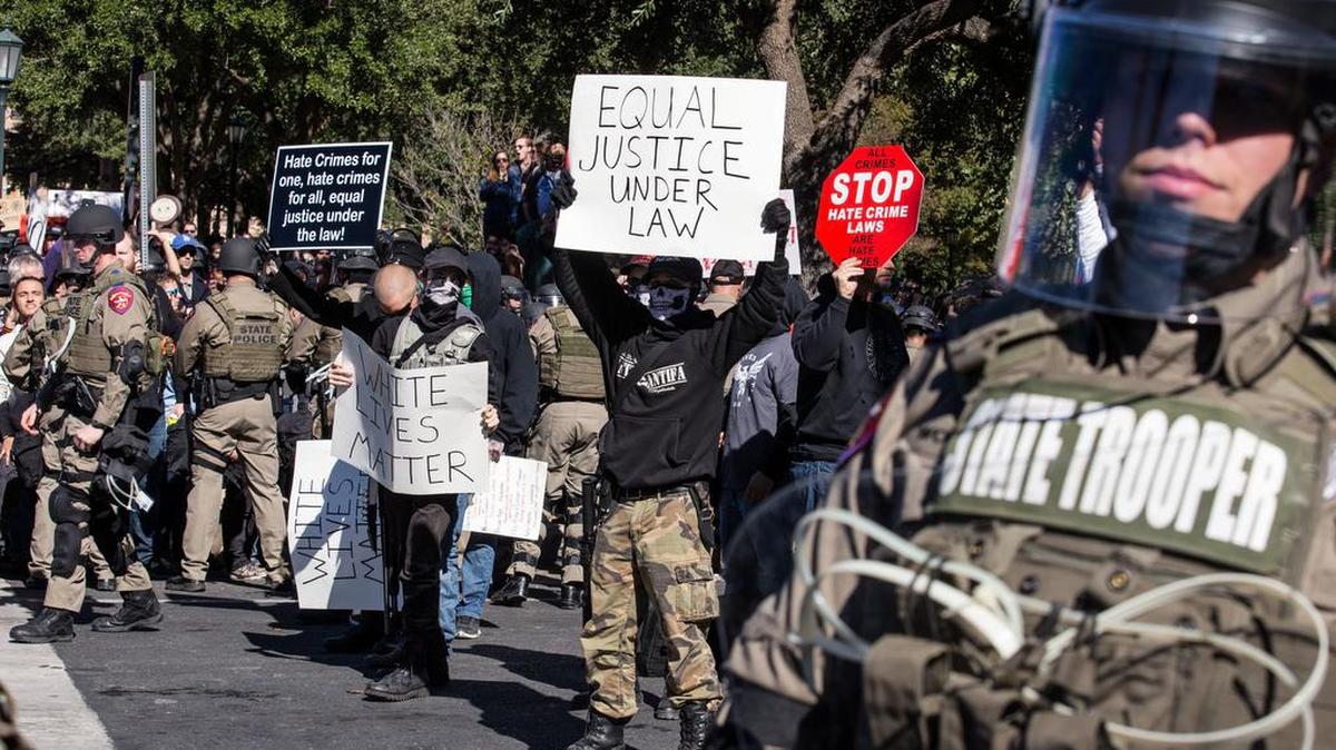 Police in riot gear hold counter-protestors away from a White Lives Matter rally in front of the Texas Capitol in Austin on Saturday. Earlier in the day, officials unveiled a monument recognizing the contributions of African-Americans to the state.