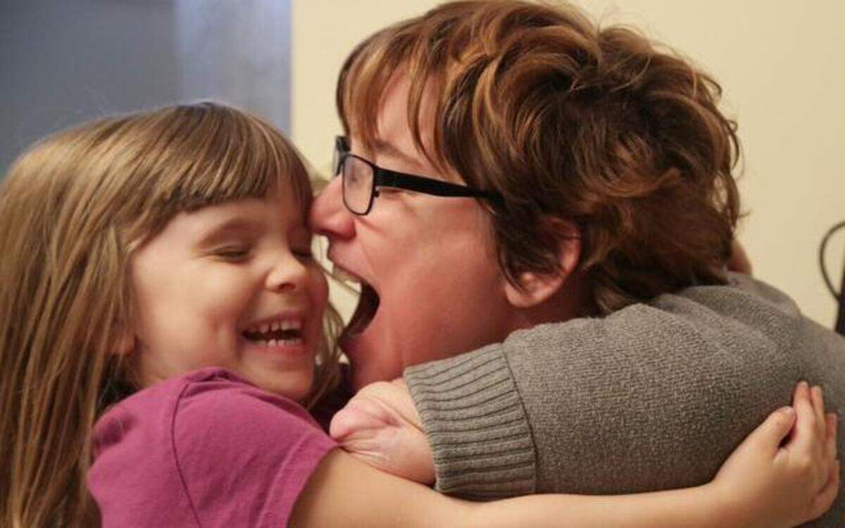 
Four-year-old Arielle Hayes hugs her mother, Katy Hayes, at their home in Kingwood on Dec. 3. Hayes, and her family have returned home to Kingwood, after spending over two years in Boston, waiting for a double arm transplant. 
