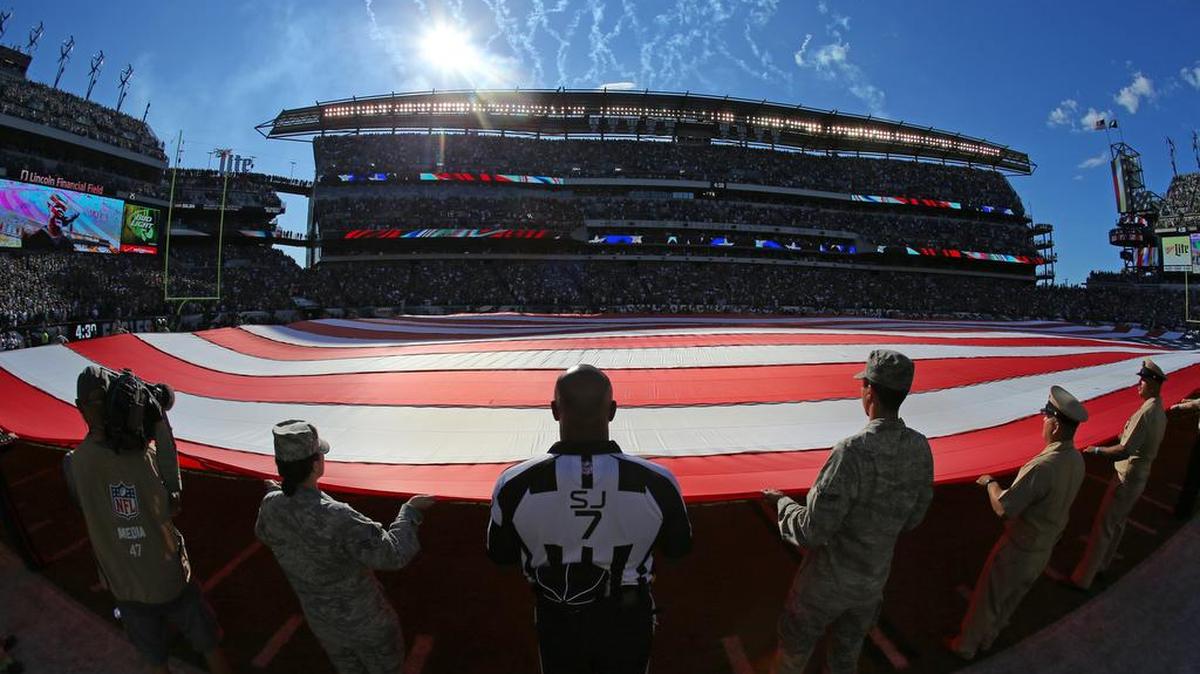 This is a common sight at NFL games: Military servicemen and women unfurl an American flag during the National Anthem before the Dallas Cowboys beat the Philadelphia Eagles 20-10 in Philadelphia on Sunday, September 20, 2015. Most fans likely don’t know teams have at times been paid to host these displays.