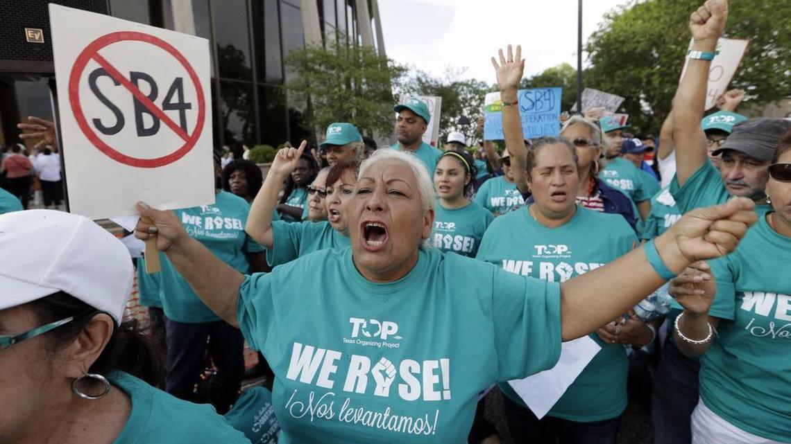 Merced Leyua, center, joins other protesters outside the Federal Courthouse to protest a new Texas "sanctuary cities" bill that aligns with the president's tougher stance on illegal immigration, Monday in San Antonio.