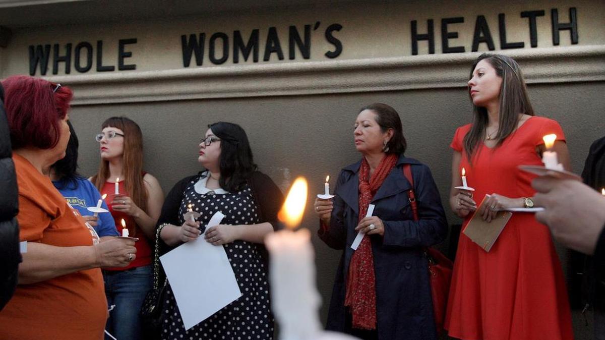 
File: In this March 6, 2014 file photo, over 40 people hold a candle light vigil in front of the Whole Women's HealthClinic in McAllen, Texas. The clinic is reopening after a federal judge on Friday, Aug. 29, 2014, blocked part of sweeping new Texas abortion restrictions that also shuttered other facilities statewide six months ago. (AP Photo/ The Monitor, Delcia Lopez, File)
