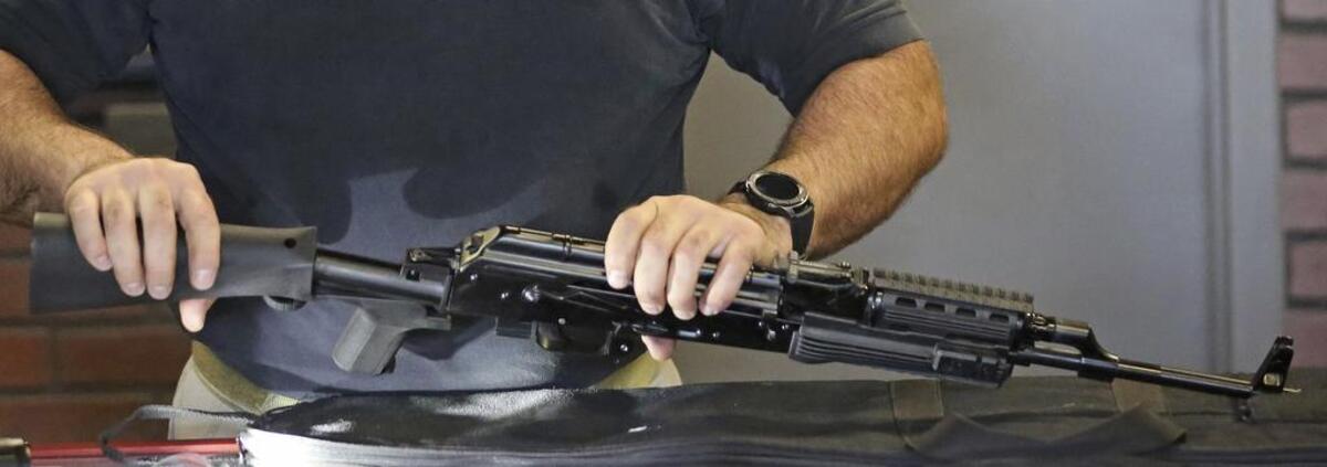 Clark Aposhian, chairman of the Utah Shooting Sports Council, demonstrates how to attach a little-known device called a “bump stock” to a semi-automatic rifle at the Gun Vault store and shooting range in South Jordan, Utah.