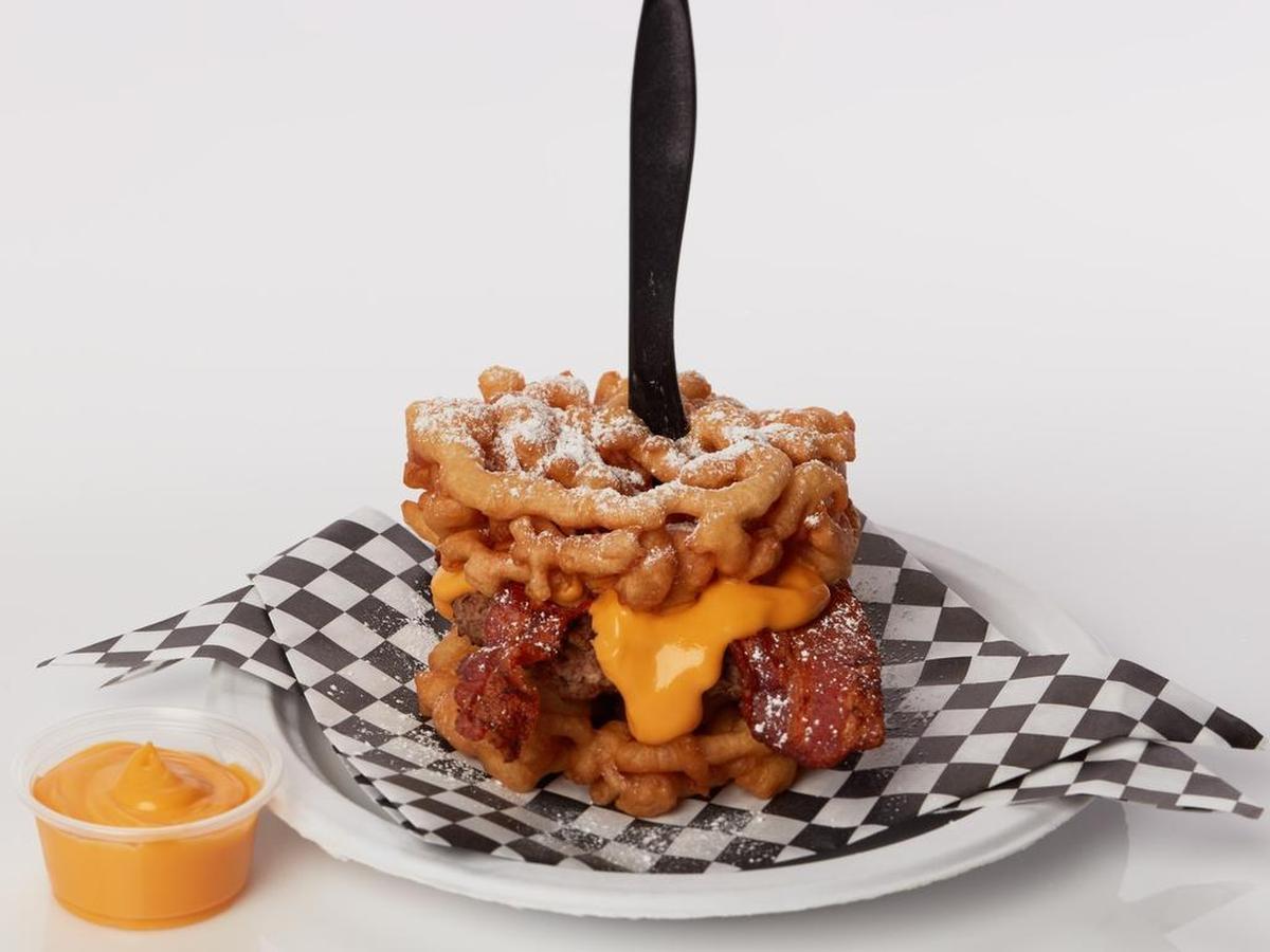 There’s no right way, or maybe there’s no wrong way, to eat a Funnel Cake Bacon Queso Burger.