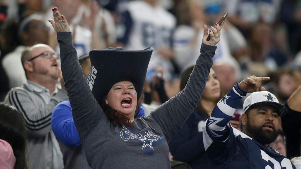 Dallas Cowboys fans cheer during a game against the Seattle Seahawks at AT&T Stadium on Dec. 24.