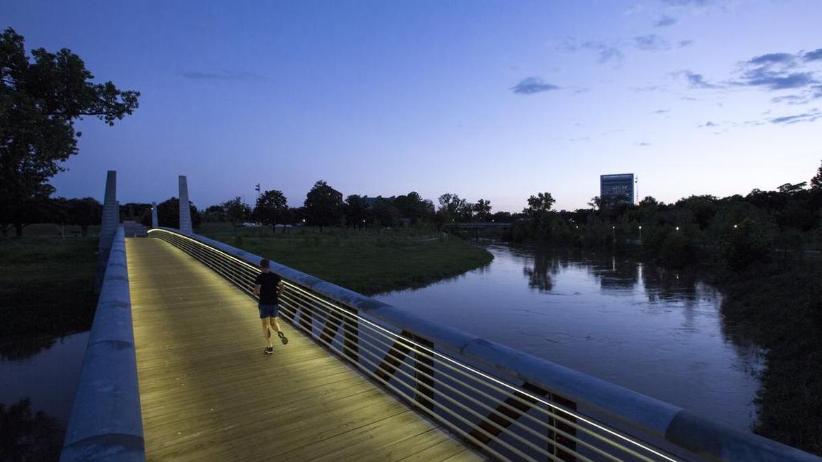 
A jogger runs across the Carruth Bridge in Buffalo Bayou Park in Houston last month. 
