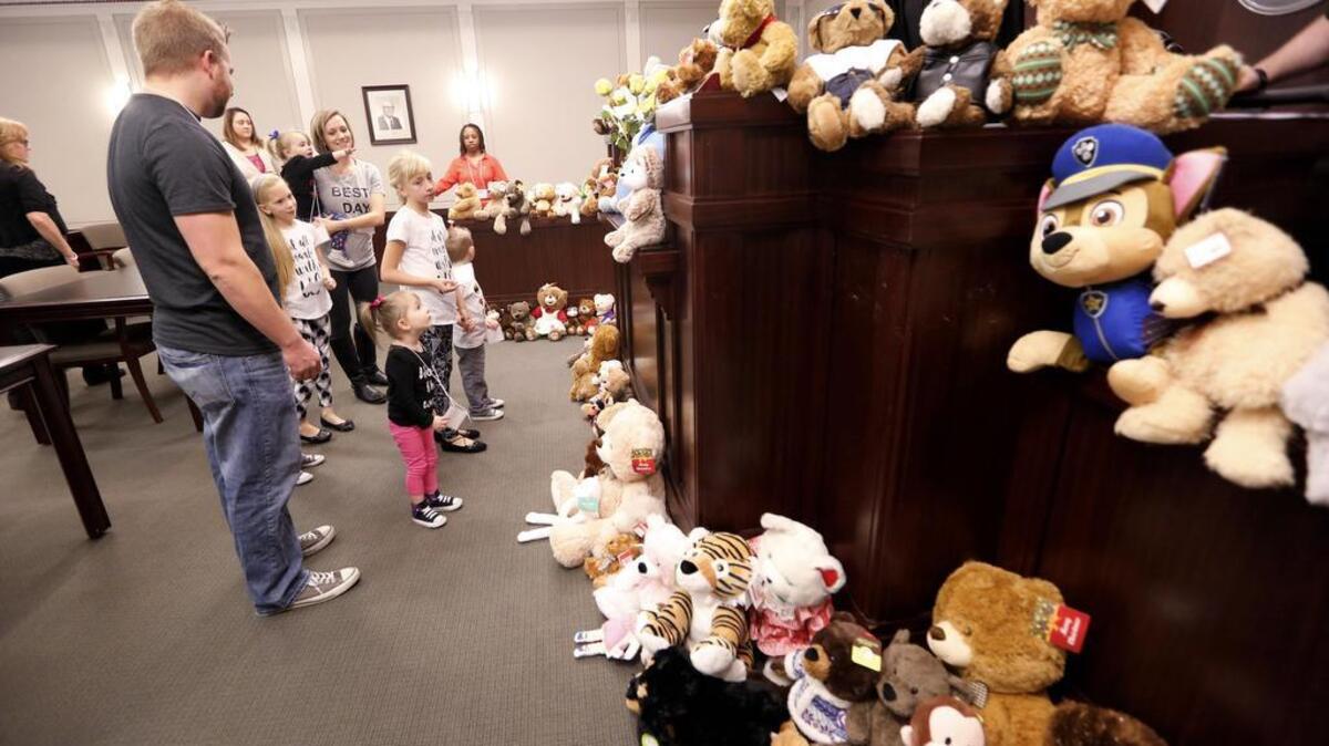 Stuffed toys for children being adopted line the courtroom on National Adoption Day in Fort Worth on November 18, 2016.