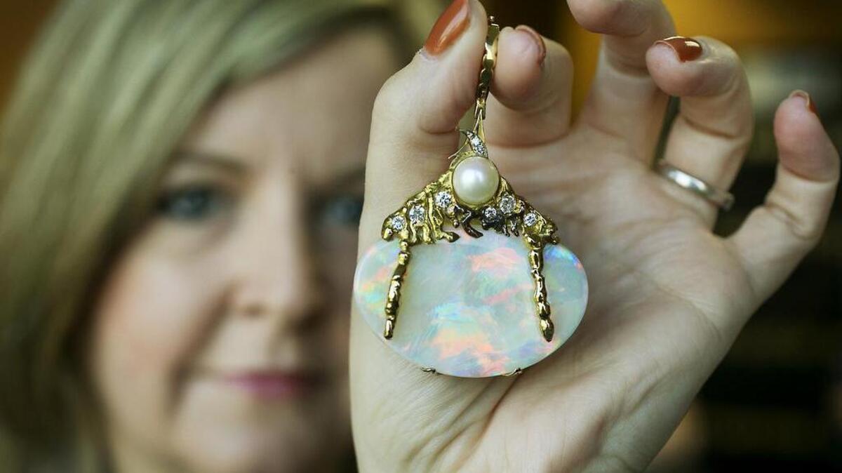 
Georgia Sanchez, assistant treasurer for the city of Austin, holds an opal given to the city from its sister city Adelaide, South Australia, in July 1983, in Austin, Texas. Now, more than three decades later, the Adelaide City Council is asking for the return of the opal, a gemstone that was once worn with pride by Austin mayors’ wives but that a city spokesman says has been sitting in a safety deposit box since the late 1990s. 
