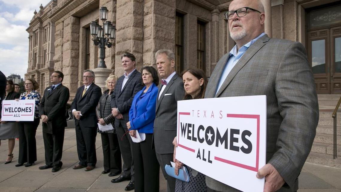 Brad Kent, chief sales and services officer for VisitDallas, holds at sign at a news conference at the Capitol in Austin to oppose Lt. Gov. Dan Patrick's bathroom bill on Wednesday, Jan. 11, 2017.
