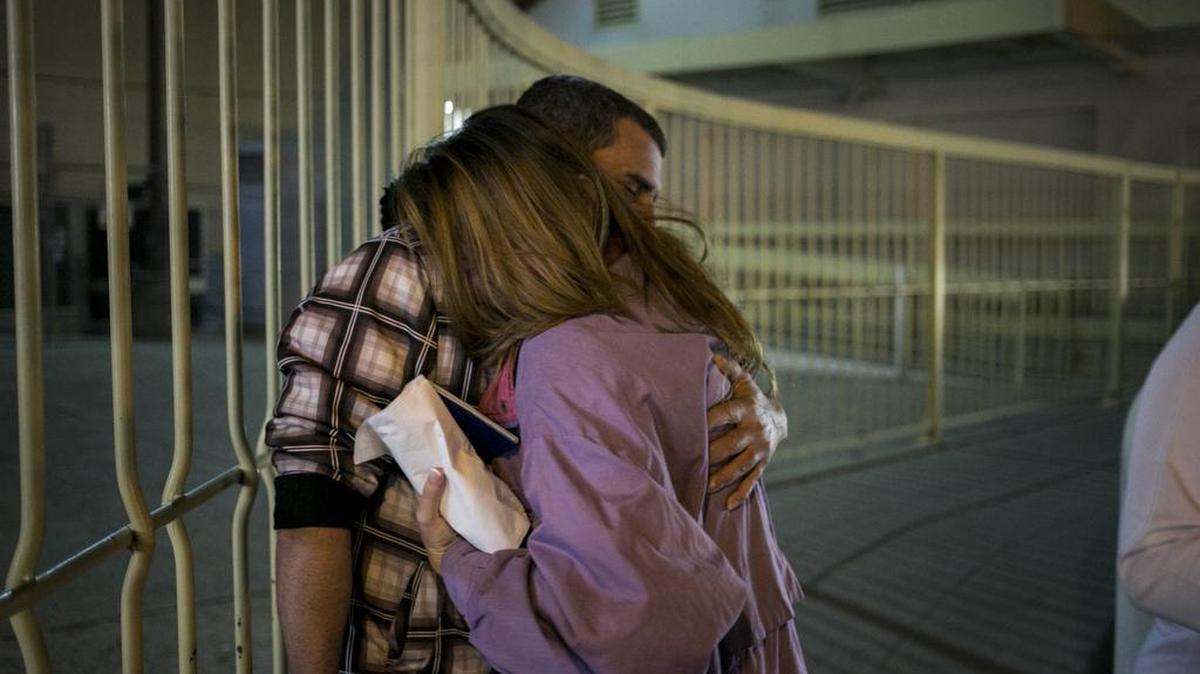 Milton Borges Gonzalez, a Cuban, greets his pregnant wife, Lisbeth Torres, after waiting all day for her to get through the port of entry in Laredo, Texas, Feb. 9, 2016. More Cubans are entering the country under a law passed in 1966, fueling tensions at the border, where Central Americans are detained and sent to immigration court.