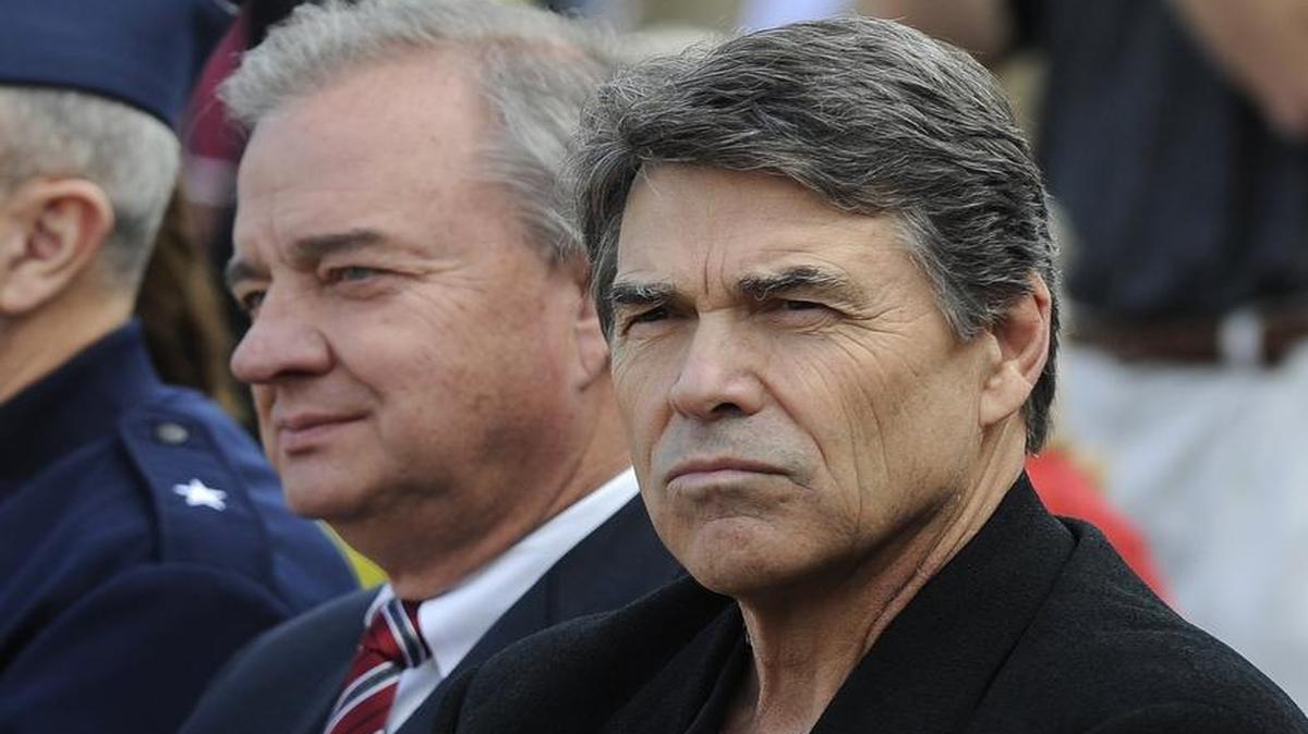 Rick Perry, right, and Texas A&M chancellor John Sharp attend ceremonies marking the reactivation of their old Corps of Cadets squadron on Jan. 11, 2013, in College Station.