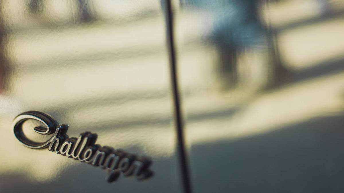Closeup of a Dodge Challenger logo. Federal authorities said a Texas man ran a fake raffle that falsely promised to give away a Dodge Challenger SRT Demon (not the vehicle pictured).