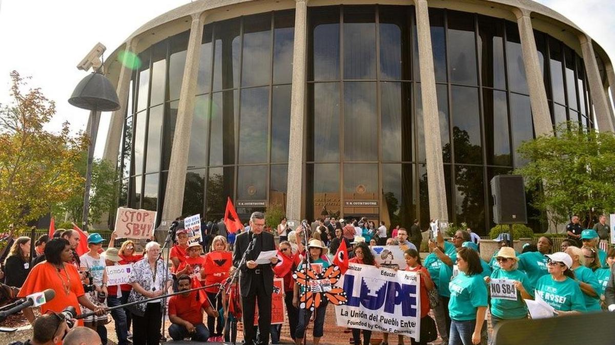 San Antonio Archbishop Gustavo Garcia-Siller speaks to protesters in front of the federal courthouse where U.S. District Judge Orlando Garcia is hearing arguments against Senate Bill 4, the so-called sanctuary cities law, on June 26, 2017.