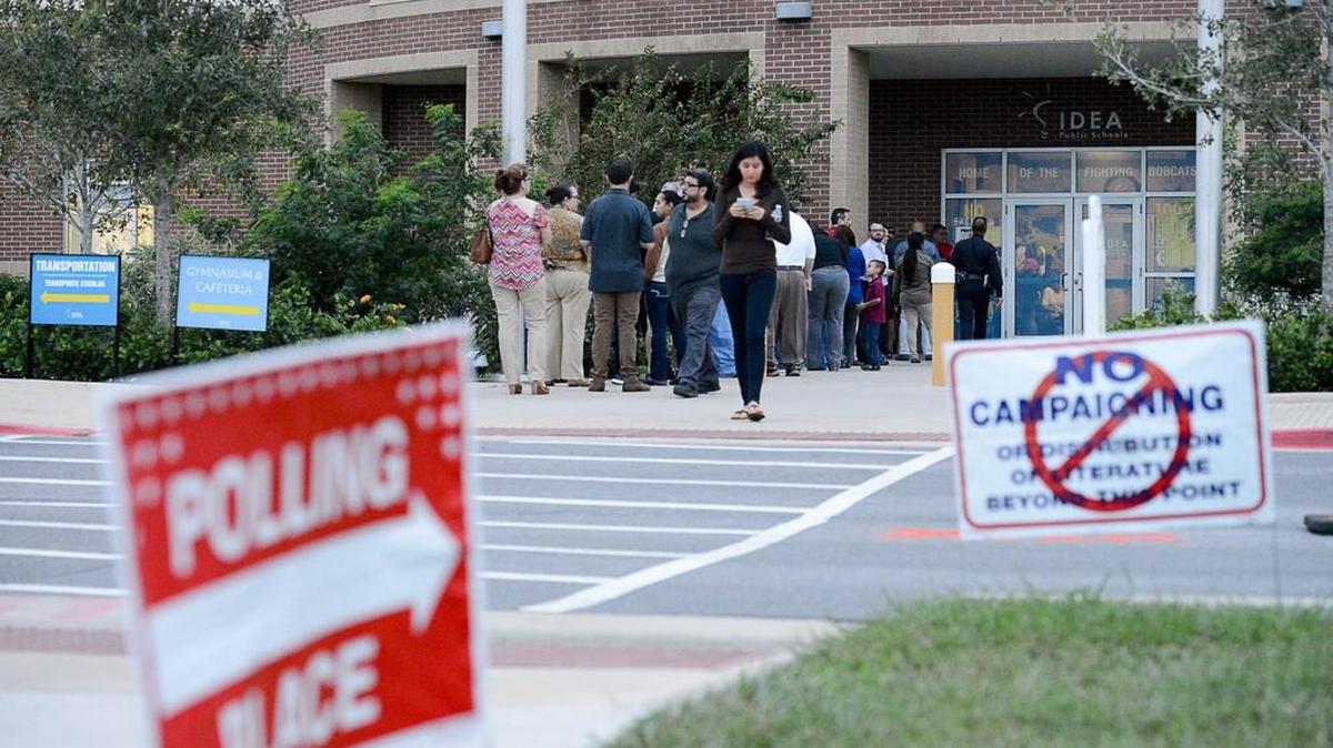 A line forms outside a polling site on Election Day, Nov. 8, at the IDEA Brownsville school campus.