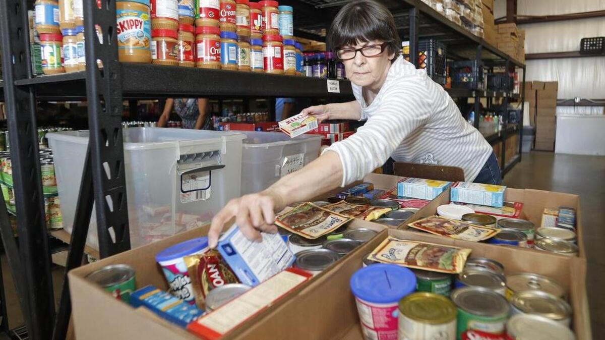 Volunteer Shirley Hambek fills boxes for Thanksgiving at the Community Storehouse Pantry in Keller on Nov. 14, 2016.