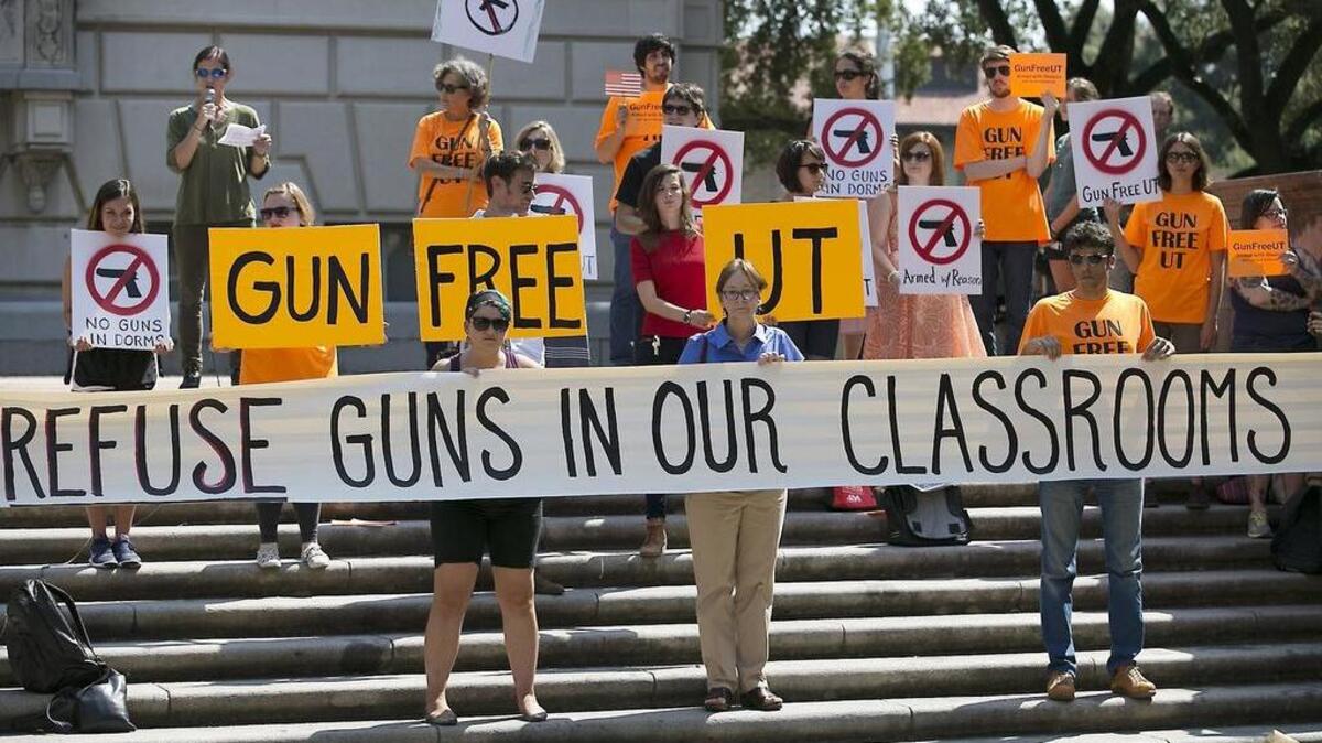 Protesters gather Oct. 1, 2015, on the West Mall of the University of Texas at Austin to oppose a new state law. Three University of Texas at Austin professors filed a lawsuit opposing the state’s campus carry law last month.