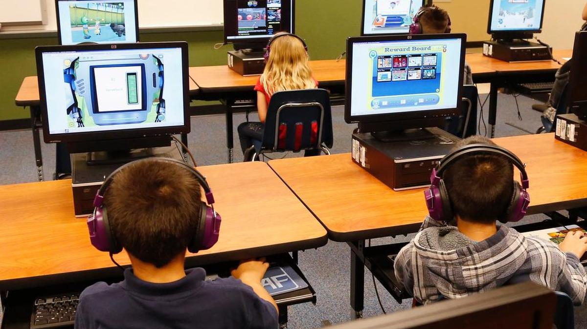 Students at an Oklahoma elementary school work at computers.