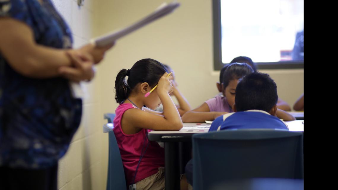 
 Children talk about a short story in Spanish during a class at the Karnes County Residential Center, a temporary home for illegal immigrant women and children. 
