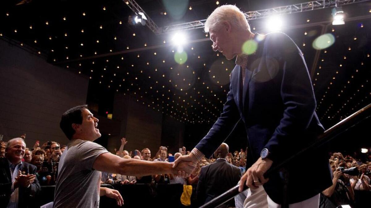 Dallas Mavericks owner Mark Cuban, left, shakes hands with former President Bill Clinton during a rally for Democratic presidential candidate Hillary Clinton on Saturday in Pittsburgh.
