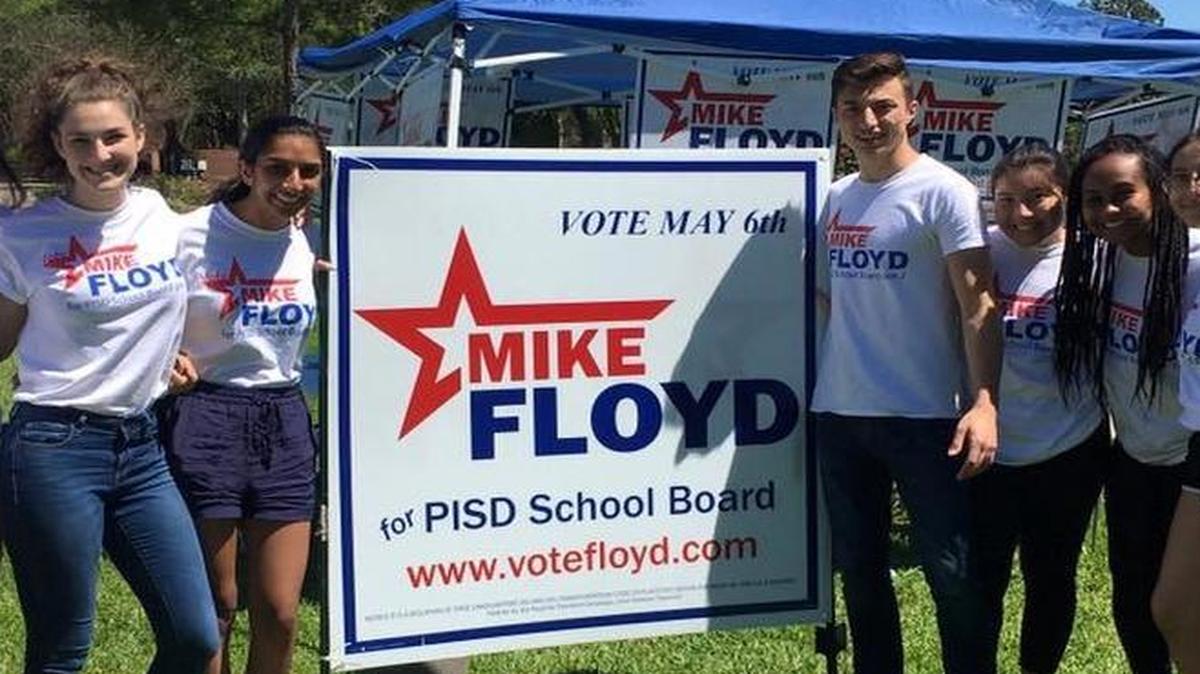 Michael Floyd, at right, next to one of his campaign signs,