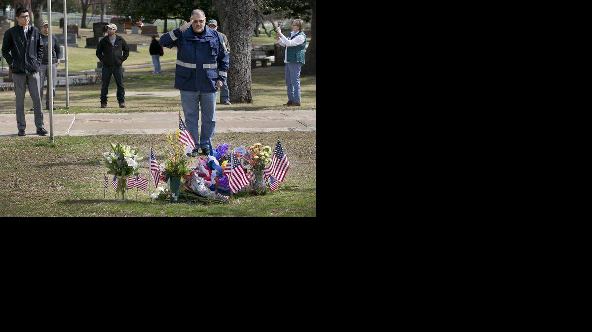 
Army veteran Alex Barragan salutes the grave of Chris Kyle, the decorated Navy SEAL sniper, at the Texas State Cemetery. 
