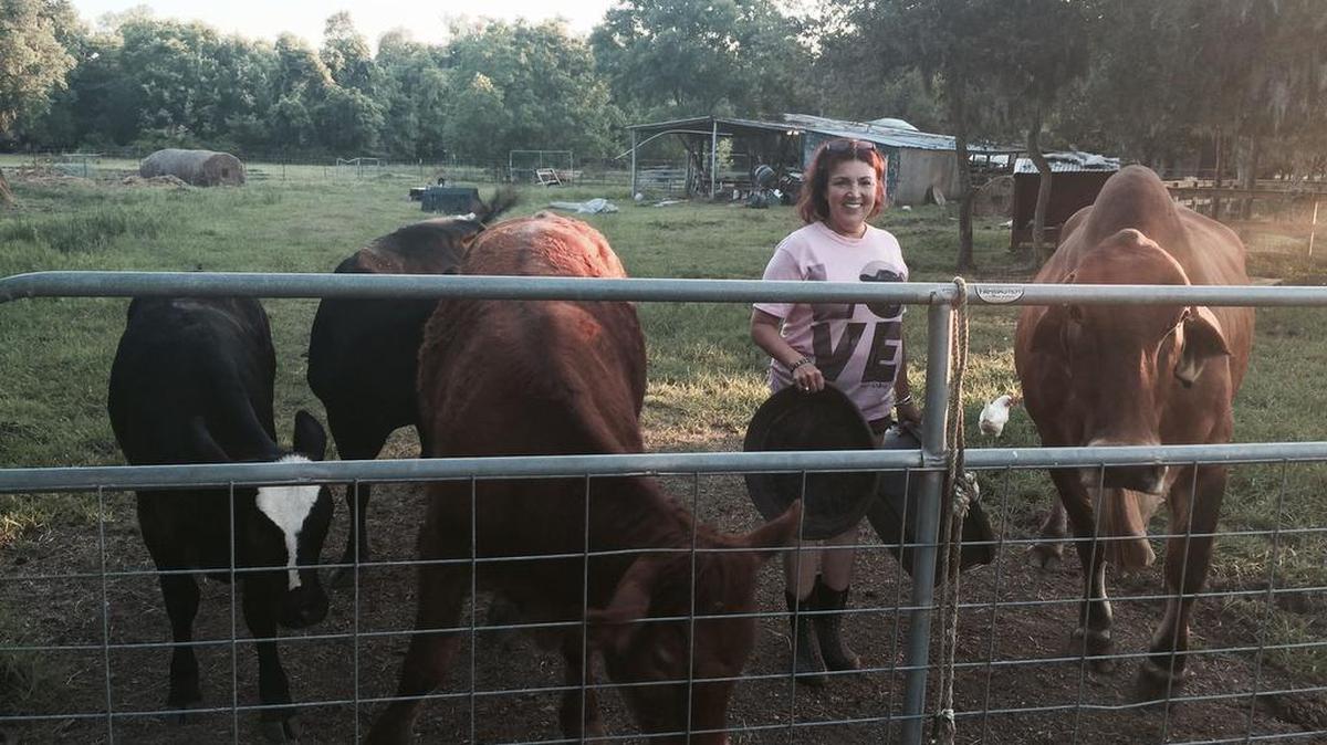 
Renee King-Sonnen stands with some of the animals at Rowdy Girl Sanctuary, a safe haven for farm animals in Angleton. 
