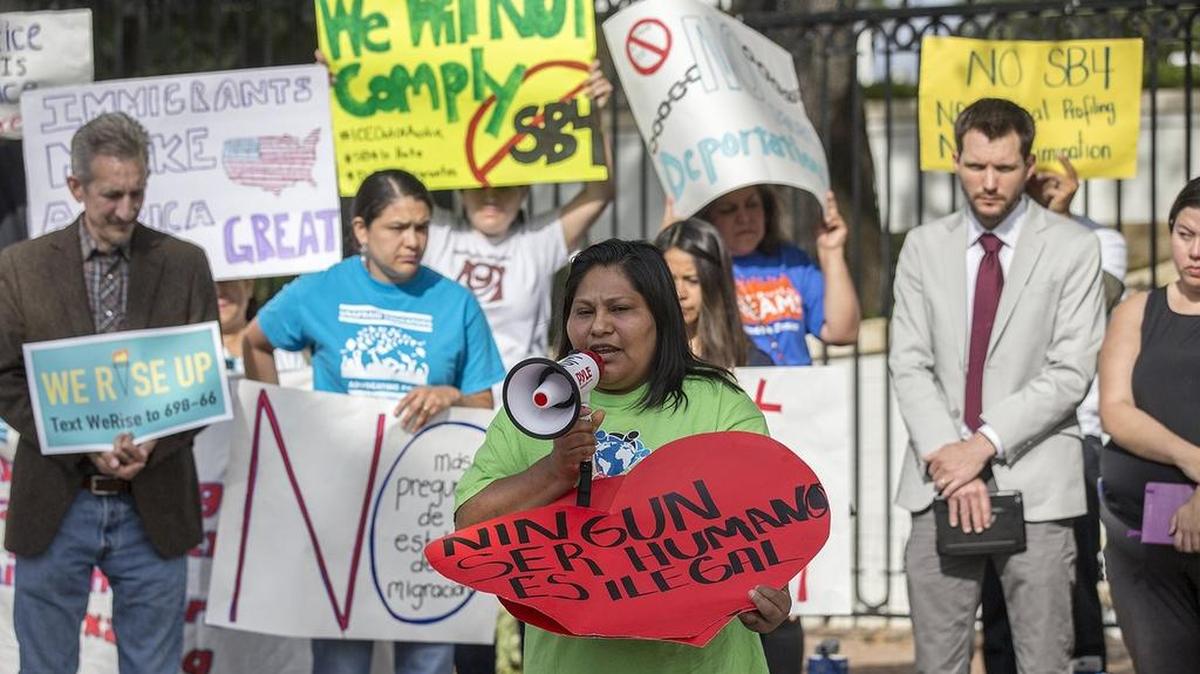 Maria Duque speaks during a protest outside of the Texas Governor’s Mansion on Monday. The gathering was to protest a sanctuary cities law that takes effect in September.