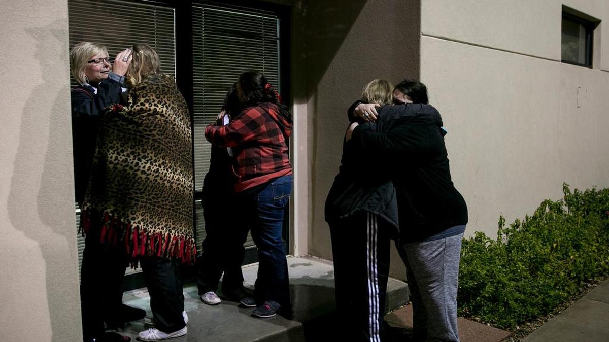 Cheerleaders, friends and mothers embrace Saturday outside the Scenic Mountain Medical Center after hearing news of a death in Big Spring.