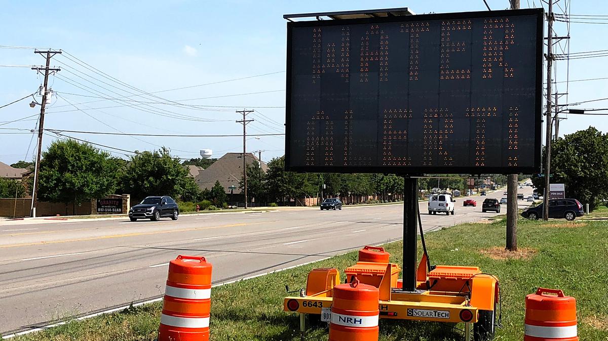 Temporary signage alerts passers-by on Davis Boulevard to the water issue in North Richland Hills, TX June 30, 2018. The sign also flashed "No Outdoor Watering" as  result of a water main break.
