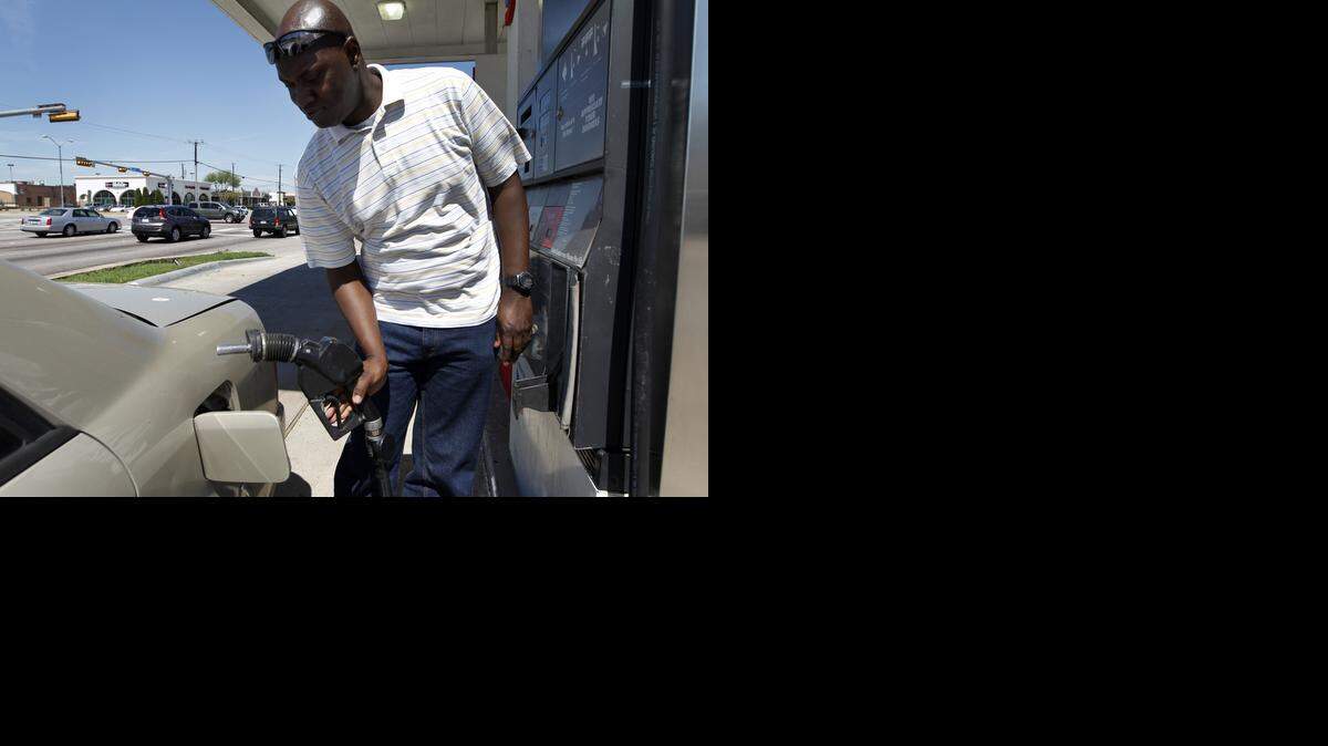 
Robert Odeph of Dallas prepares to fill his car with gas at a Chevron filling station
