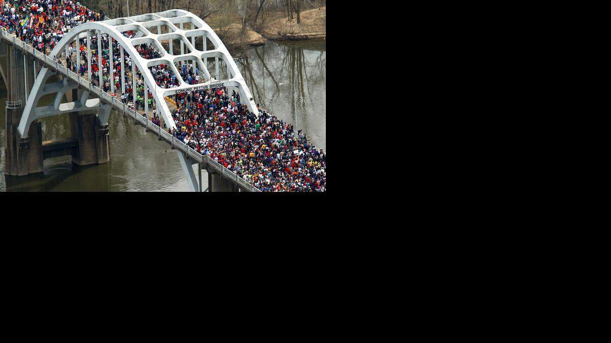 
 Crowd  moves in a symbolic walk across the Edmund Pettus Bridge in Selma, Ala. on March 8 to mark the 50th anniversary of “Bloody Sunday.” 

