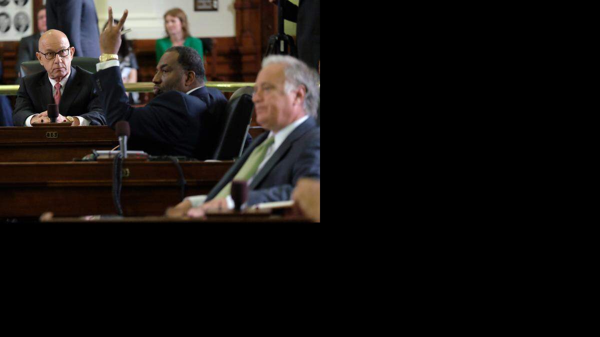 
State Sen. John Whitmire, D- Houston, left, looks on as Sen. Royce West, D- Dallas, raises two fingers signaling a no vote on open carry. 
