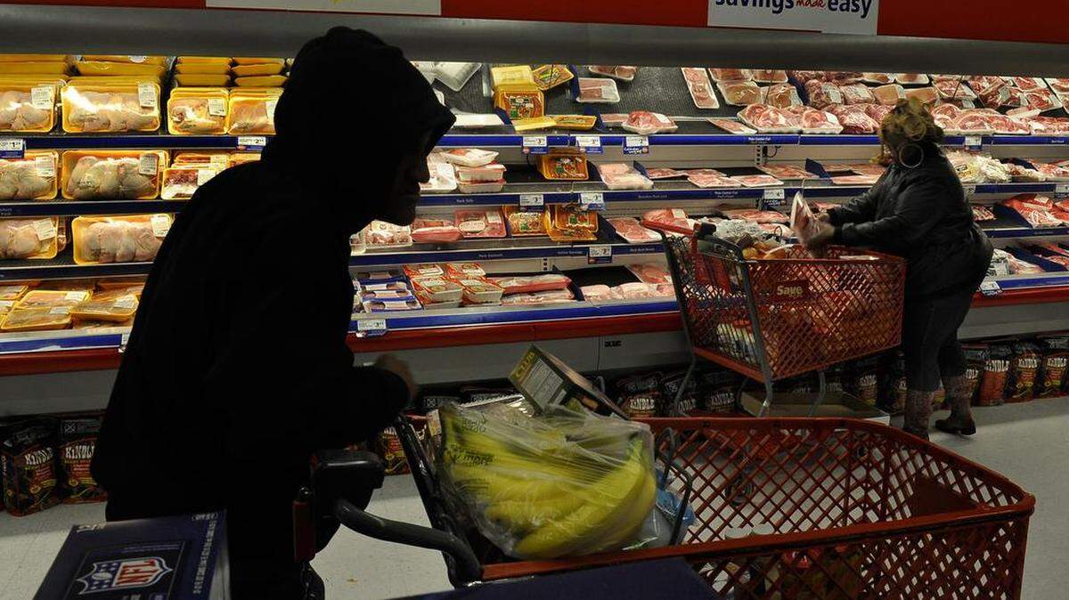 Anthony, 15, waits for his mother Raphael Richmond who is loading up on meat at the discount grocery store where they do a big once-a-month shopping trip on the day that their monthly SNAP account is re-funded