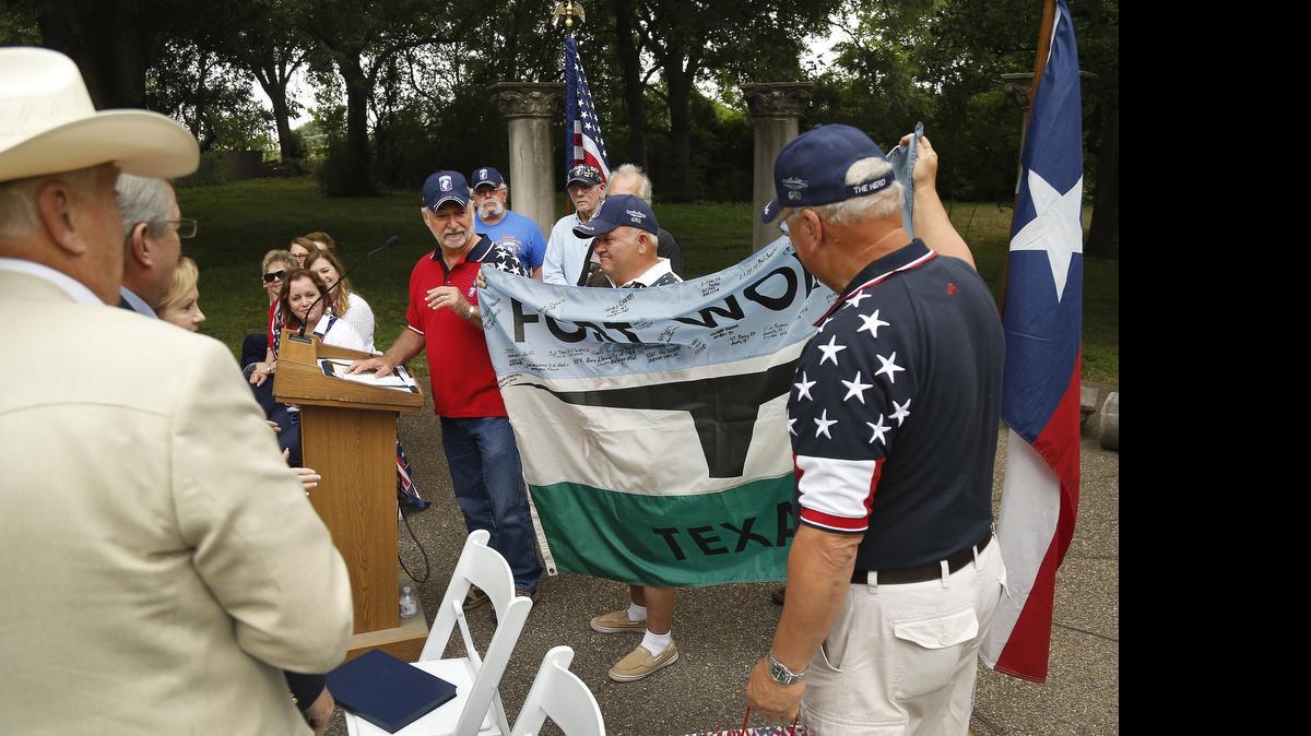 
Members of Charlie Company, 173rd, present City Councilmen Jungus Jordan and Dennis Shingleton a signed flag the group flew in the Vietnam War. The presentation was made during the Daughters of the American Revolution Flag Day Celebration at the Charlie Company Vietnam Memorial at the Fort Worth Botanic Garden in Fort Worth, Texas on Saturday, June 13, 2015.
